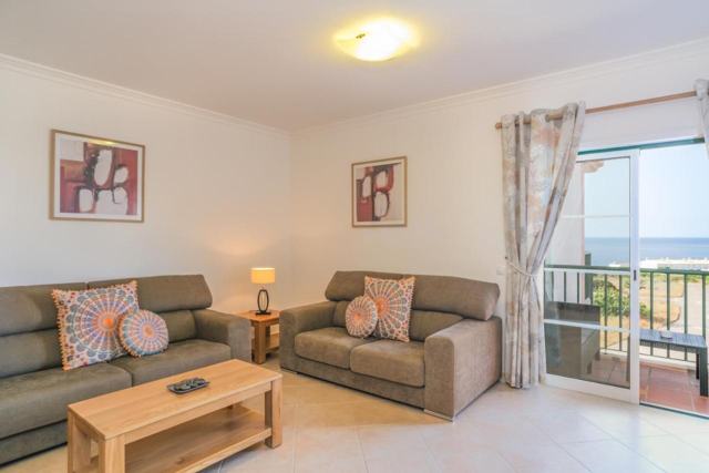 Living room with two sofas and doors to the balcony